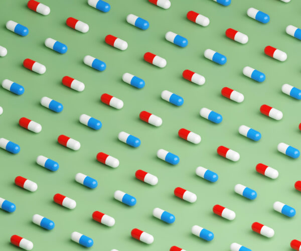 Medicine capsules pattern on light green background